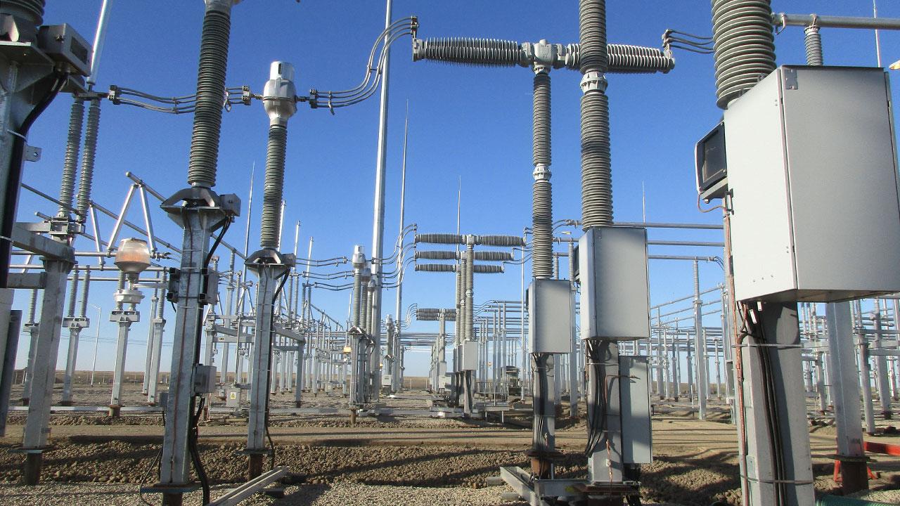 Electrical substation equipment in front of a blue sky